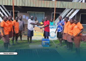 Constituency Project Officer (CPO), Stephen Lupeqeto handover ICT equipment and solar system set to Leona Community High School management rep, witnessed by students.