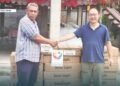 Justin Tanema, Constituency Development Officer (CDO) for TVC receives the donated goods and supplies from PRC Embassy, Head of Political Section Gu Wenlong.