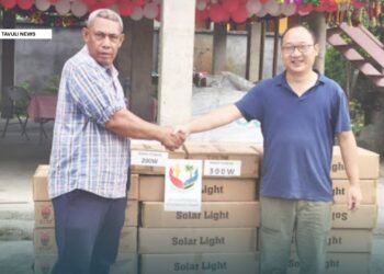 Justin Tanema, Constituency Development Officer (CDO) for TVC receives the donated goods and supplies from PRC Embassy, Head of Political Section Gu Wenlong.