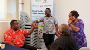Mr Alphonse Botu from the Ministry of Women, Youth, Children, and Family Affairs (seated), sharing ideas with colleagues from the Ministry of Education and Human Resources Development, and the National Rehabilitation and Disability Division.