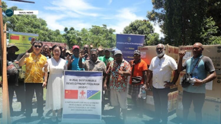 Counsellor Li Qinghua of the Chinese Embassy in the Solomon Islands (second from the left), alongside Constituency Development Officer John Butaifai (third from the right), at the handover ceremony. They are joined by MRD Permanent Secretary John Misite’e (second from the right), constituency officers, community representatives, and senior MRD officials, with a Chinese Embassy representative on the far left.