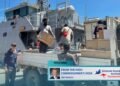 High Commissioner Jeff Roach observes the unloading of supplies from the Guardian- class patrol boat Gizo.