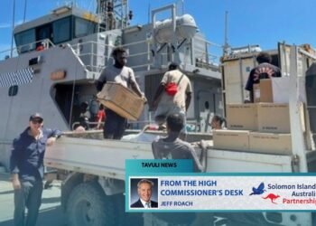 High Commissioner Jeff Roach observes the unloading of supplies from the Guardian- class patrol boat Gizo.