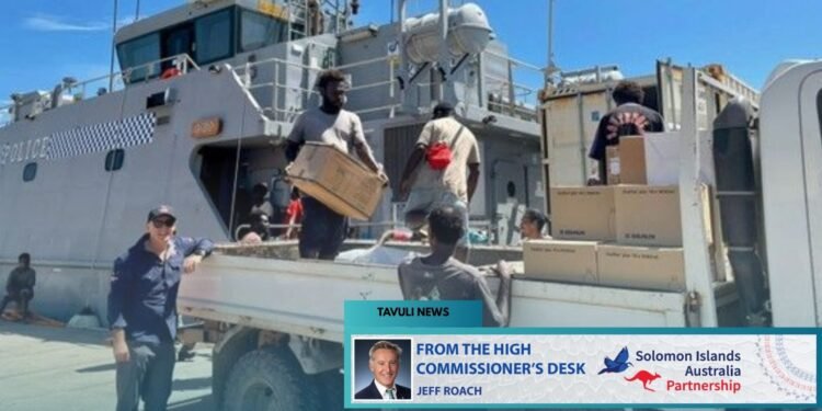 High Commissioner Jeff Roach observes the unloading of supplies from the Guardian- class patrol boat Gizo.