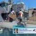High Commissioner Jeff Roach observes the unloading of supplies from the Guardian- class patrol boat Gizo.