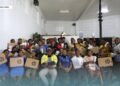 Derrick Manu’ari, together with Smart Technology Managing Director Rolex Sitana, seated in the front row, centre, along with constituency officers and student recipients during the handover last Thursday.