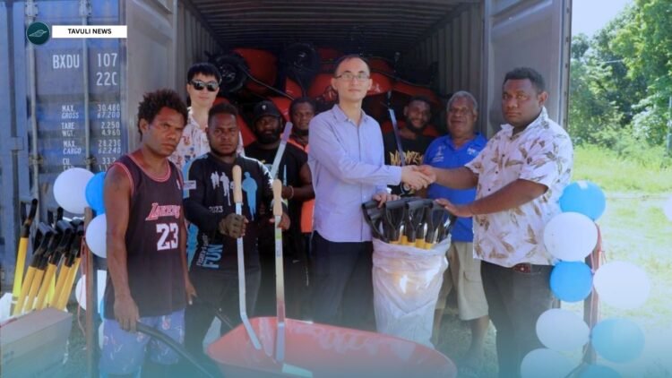 A formal handover of the agricultural tools from PRC to Central Makira Constituency. Pictured, Constituency Accountant Harry Waiwariki receiving the assistance from the Chinese Embassy in Solomon Islands, Secretary Mr Wang Jinzhao in the presence of CDO Gravis Tahiri in blue shirt from behind and few constituency reps.